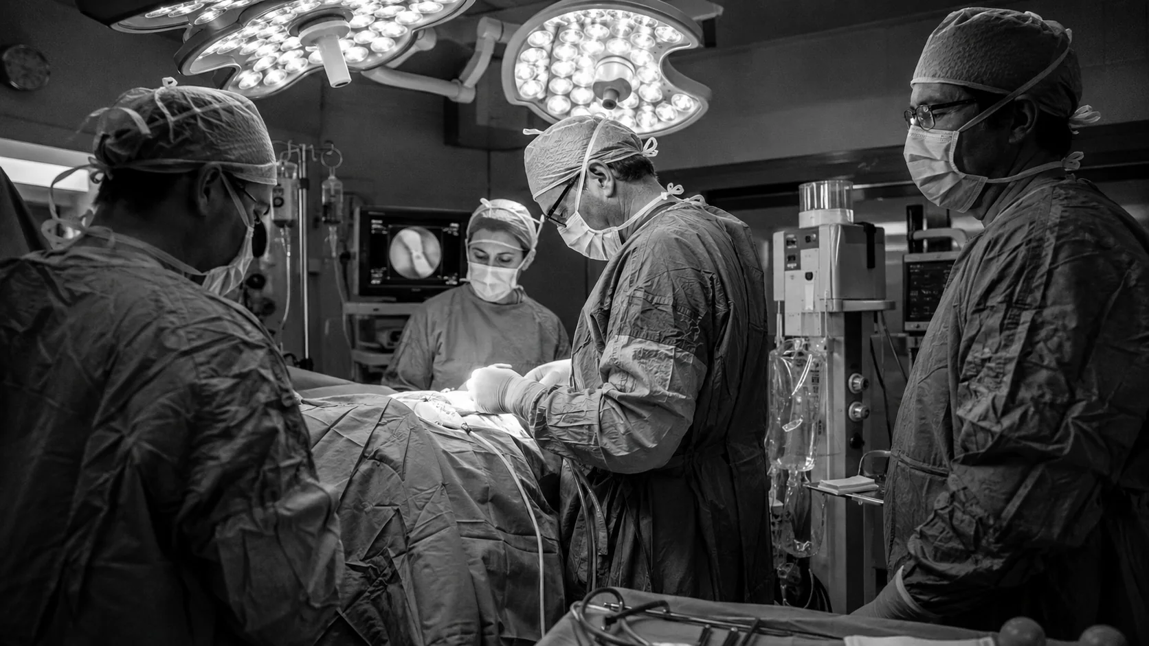 Urology surgical team performing a procedure in an operating room